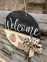 Load image into Gallery viewer, 16” Welcome Cowprint Round Doorhanger
