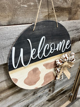 Load image into Gallery viewer, 16” Welcome Cowprint Round Doorhanger
